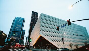 Explore Los Angeles architecture with futuristic buildings and city traffic captured at dusk.