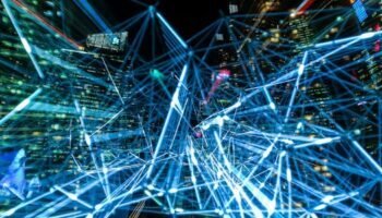 Dynamic urban scene showcasing interconnected light trails representing digital communication networks.